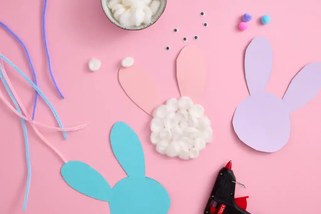 Cotton Ball Bunny Craft - Cultivating Brilliant Minds a bunny silhouette cut out of construction paper with a cotton balls glued on