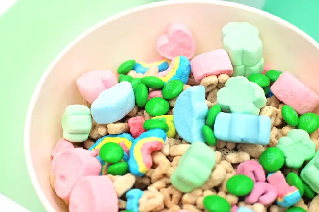 Leprechaun Bait Snack Mix - Cultivating Brilliant Minds chex mix, lucky charms,, big lucky charm marshmallows, and green m&ms in a bowl
