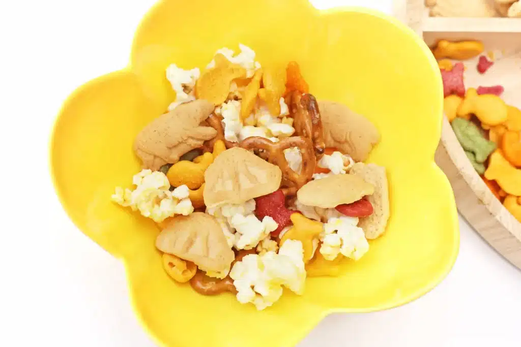 Zoo Snack Mix - Cultivating Brilliant Minds a zoo snack tray that has animal crackers, goldfish, pretzels, and popcorn