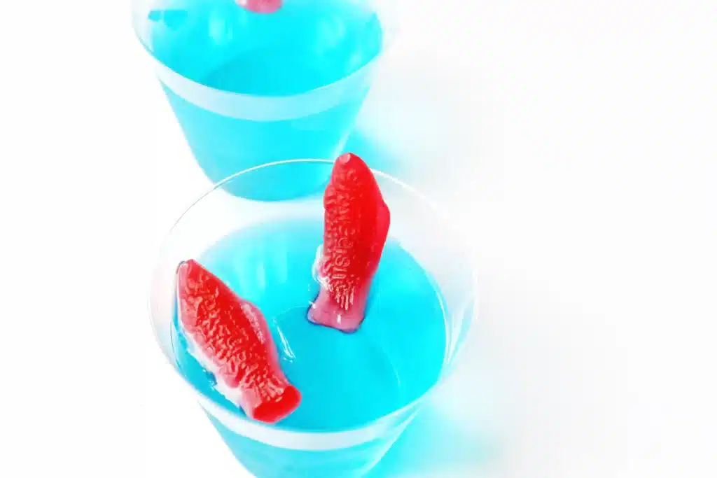 Dr. Seuss One Fish Two Fish Jello Cups - Cultivating Brilliant Minds blue jello cups with red swedish fish on top