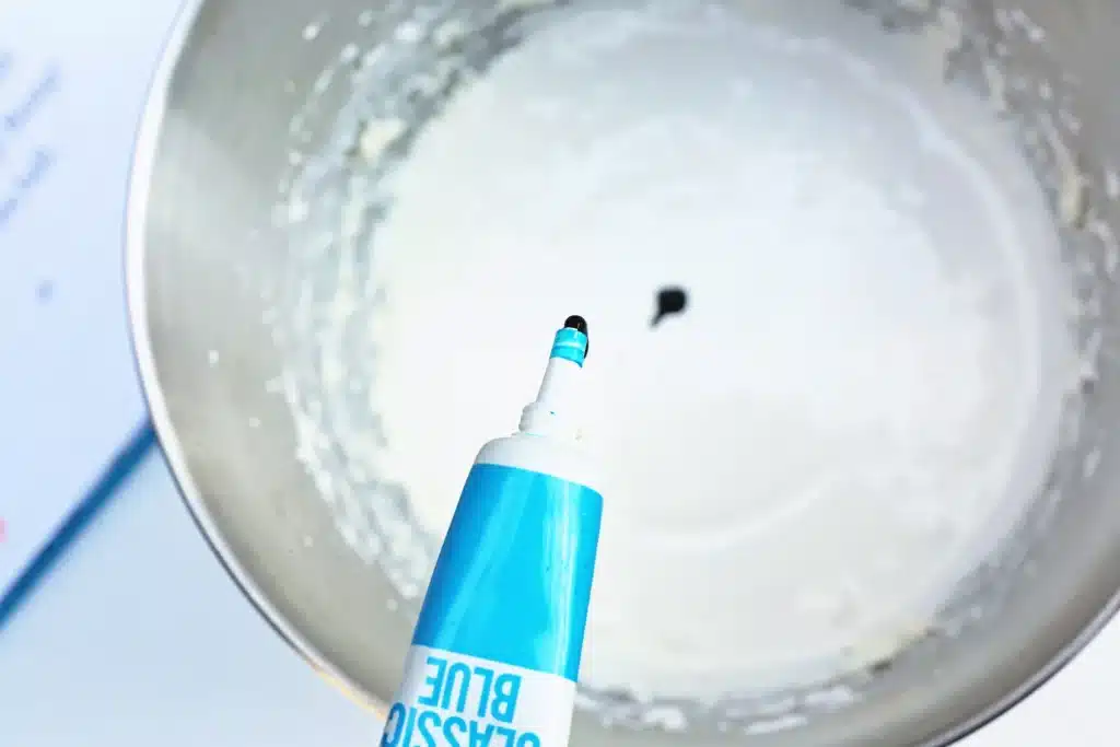 Thing 1 Thing 2 Fruit Dip - Cultivating Brilliant Minds adding blue food dye to the cream cheese and whipped topping mixture