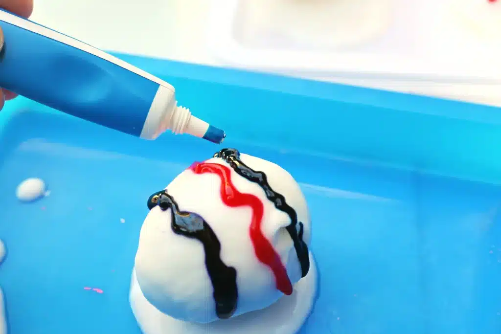 Galaxy Easter Eggs - Cultivating Brilliant Minds an easter egg covered in a baking soda paste with colored food coloring decorations on top