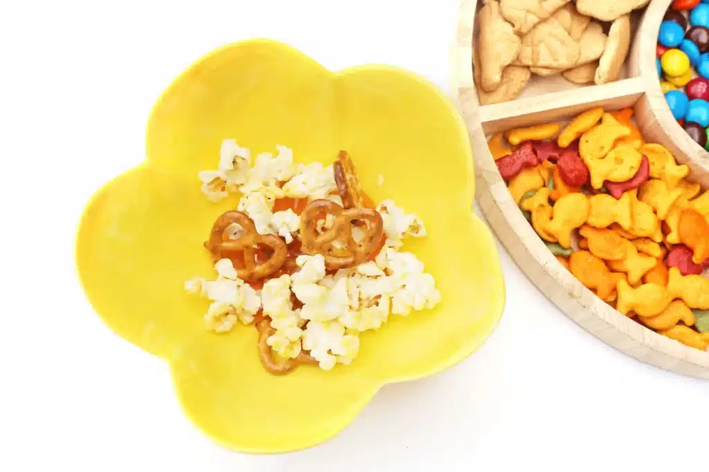 Zoo Snack Mix - Cultivating Brilliant Minds popcorn and pretzels in a yellow bowl