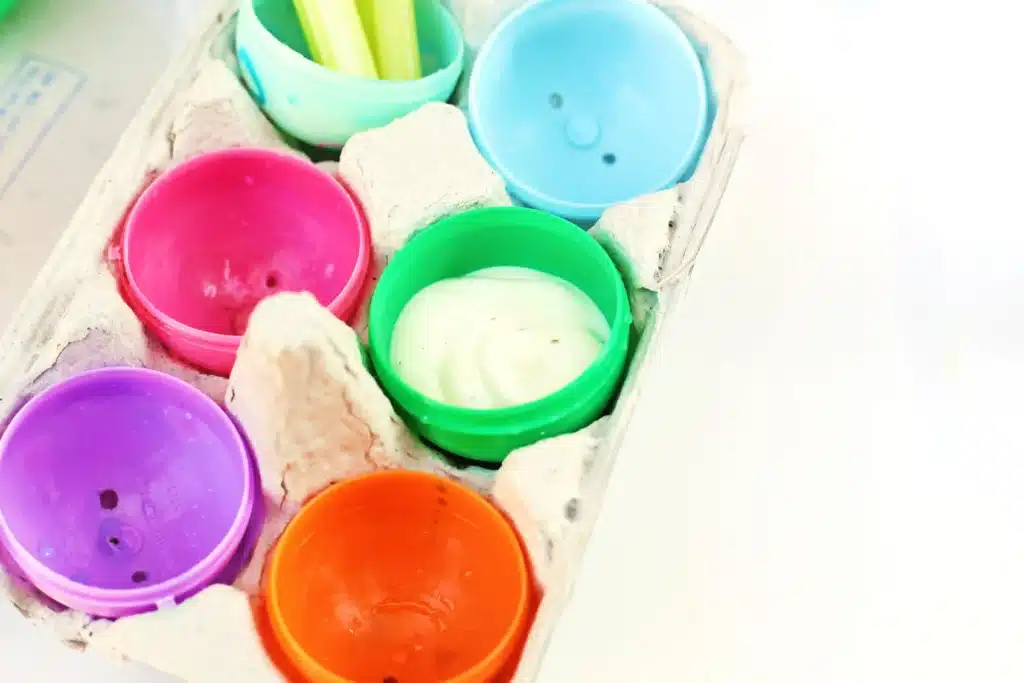 Easter Egg Snack Tray - Cultivating Brilliant Minds plastic eggs inside a cardboard egg carton. one egg has ranch inside it