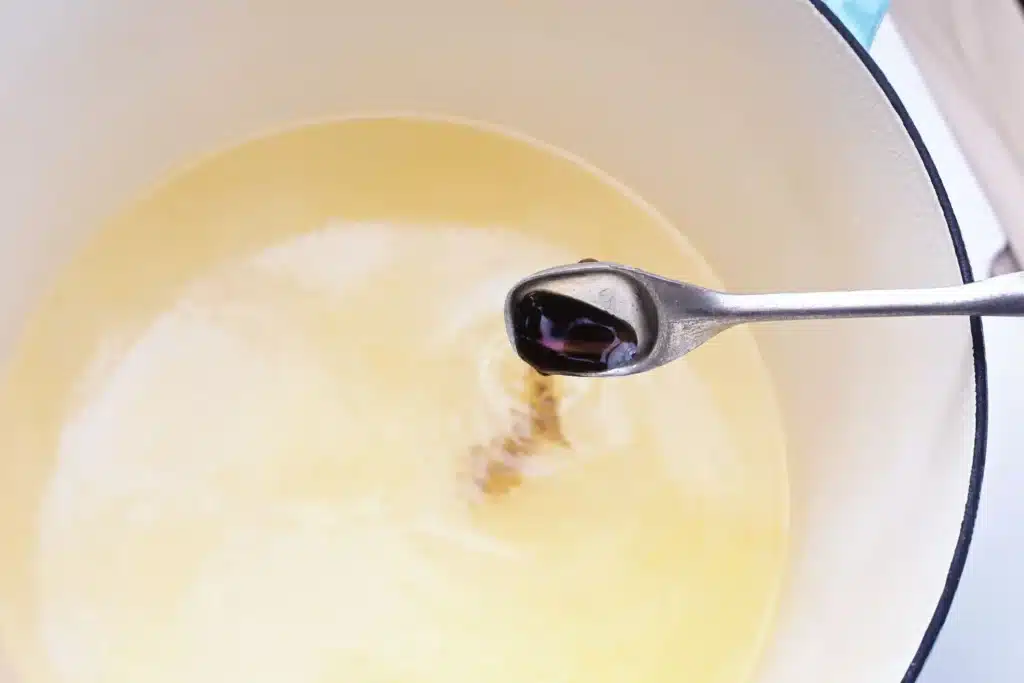 Sheep Popcorn Balls - Cultivating Brilliant Minds adding vanilla to the sugar, water, corn syrup, salt, and butter mixture