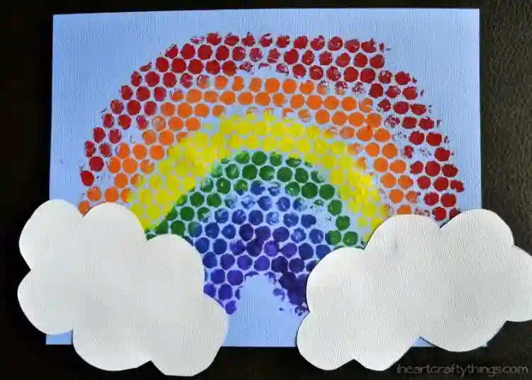 Easy Rainbow Art Projects for St. Patrick's Day - Cultivating Brilliant Minds a rainbow stamped on a piece of paper with bubble wrap