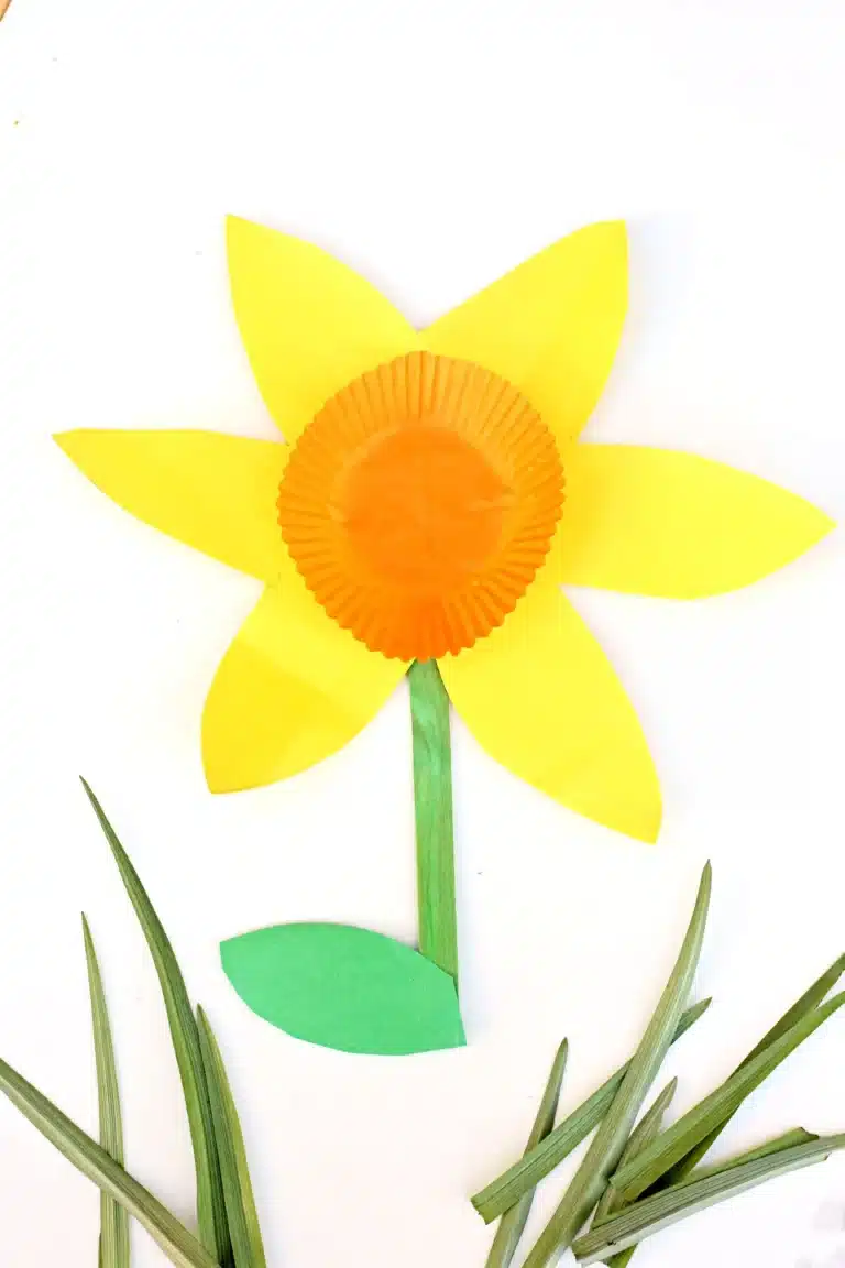 daffodils made out of yellow and green construction paper and an orange cupcake liner
