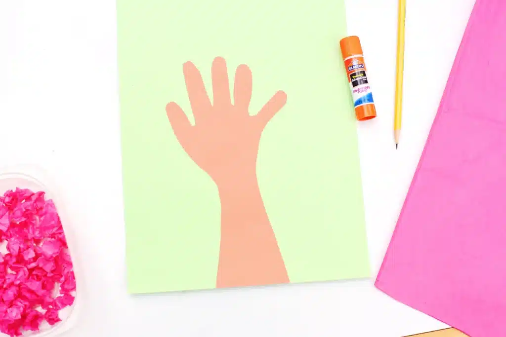 Handprint Cherry Blossom Tree - Cultivating Brilliant Minds a handprint cut out of brown paper and glued on to green paper