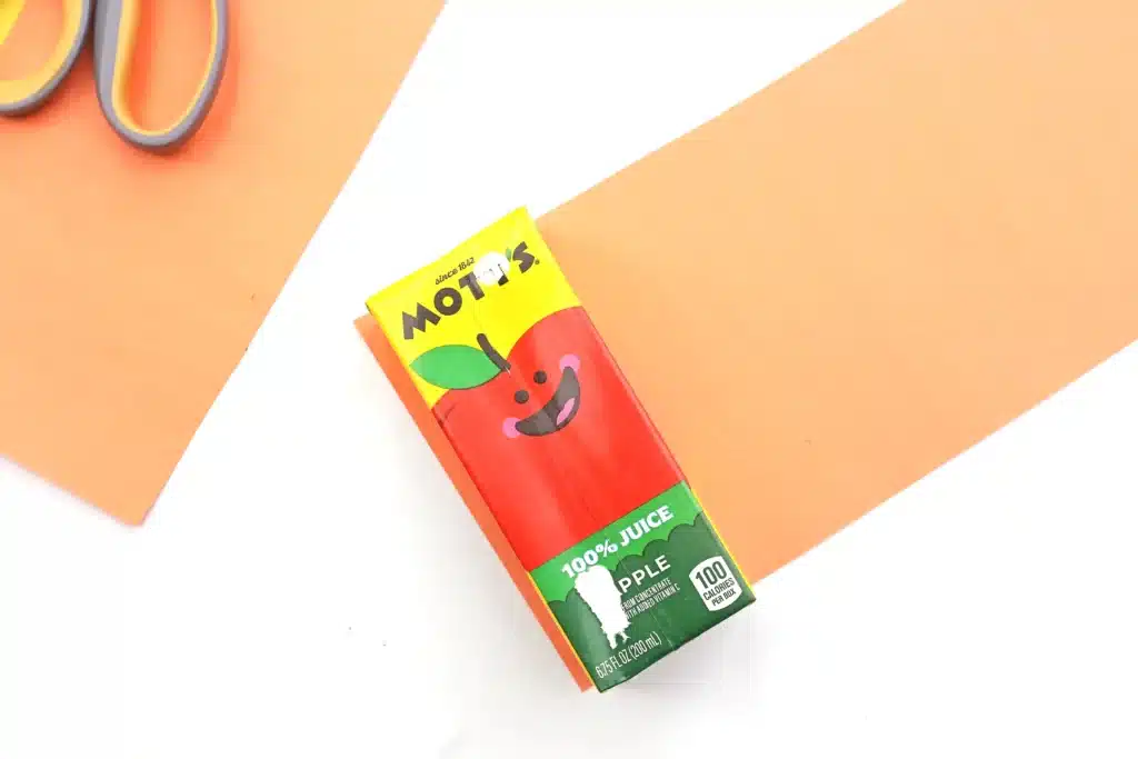 Dr. Seuss The Lorax Juice Boxes - Cultivating Brilliant Minds a juice box on top of orange paper cut to the same size as the juice box