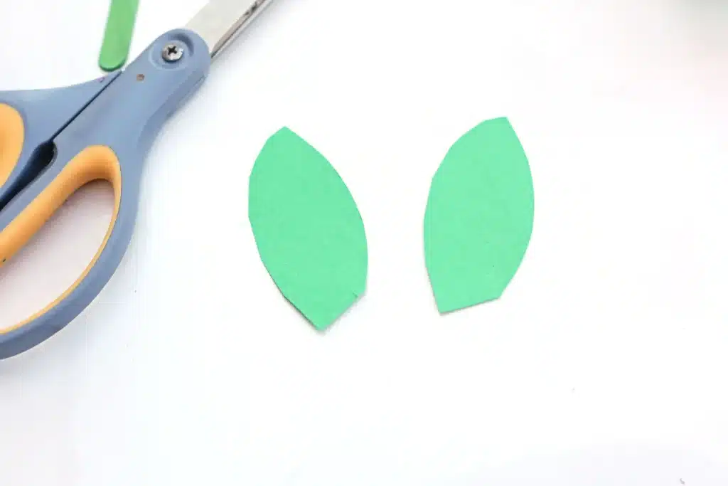 Cupcake Liner Daffodil - Cultivating Brilliant Minds leaves cut out of green construction paper