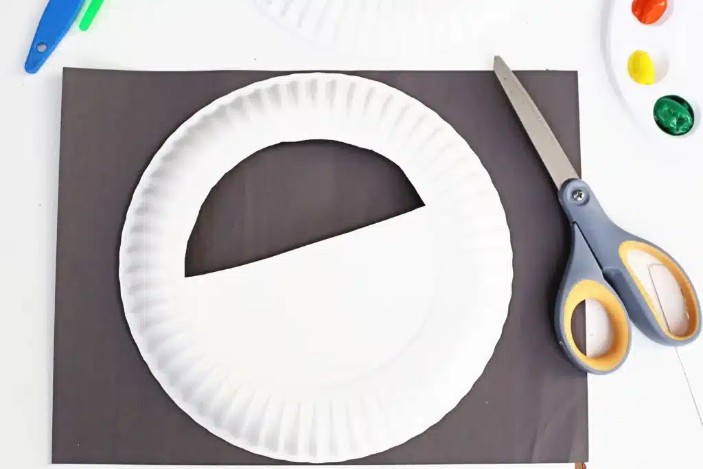 Paper Plate Pot of Gold with Fingerprint Coins - Cultivating Brilliant Minds a paper plate with a semi circle cut in the middle