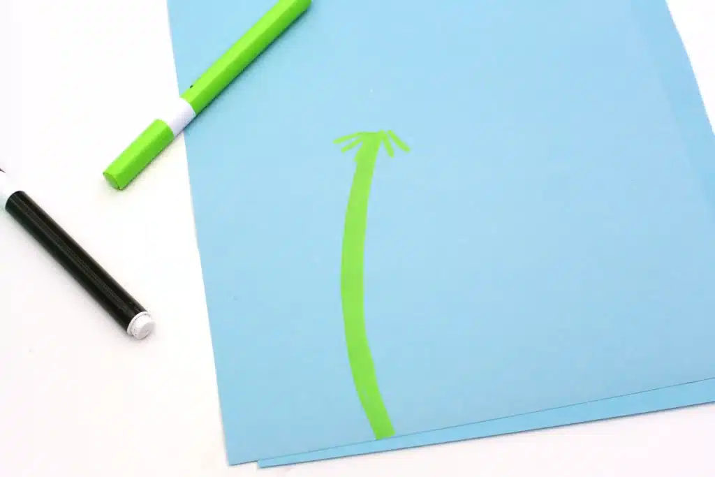 Fingerprint Dandelions - Cultivating Brilliant Minds a green stem drawn on blue paper