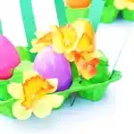 Easter Egg Garden Craft - Cultivating Brilliant Minds an easter egg garden craft that has an egg carton painted green with plastic easter eggs, flowers, and strips of green paper for grass