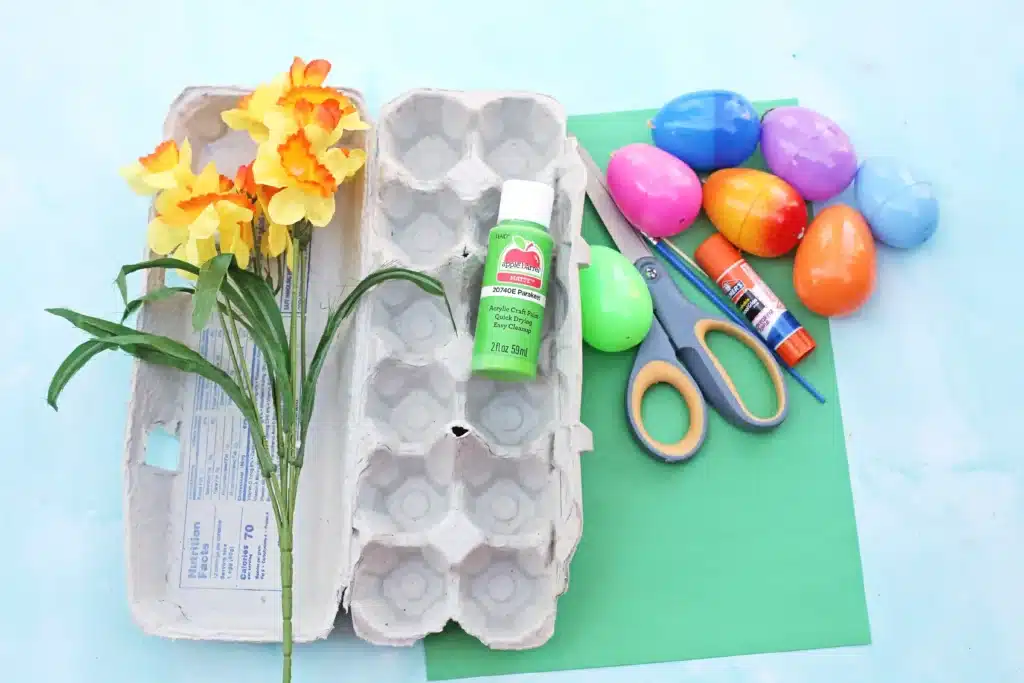 Easter Egg Garden Craft - Cultivating Brilliant Minds fake flowers, egg carton, green paint, green construction paper, scissors, glue, and plastic easter eggs