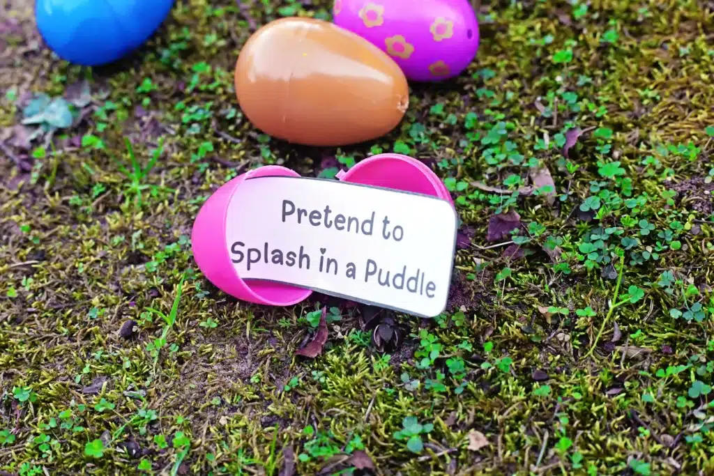 Easter Egg Hunt Movement Game - Cultivating Brilliant Minds an easter egg hunt movement game that has a strip of paper inside the egg that says "pretend to splash in a puddle"