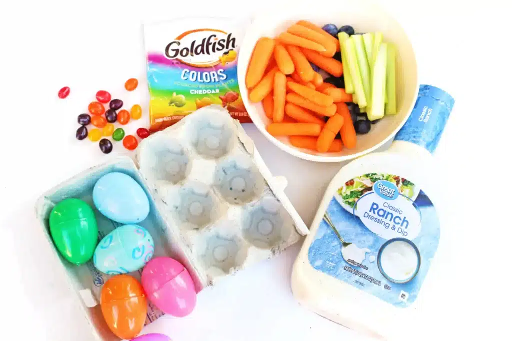 Easter Egg Snack Tray - Cultivating Brilliant Minds jelly beans, goldfish, carrots, blueberries, celery, plastic eggs, ranch dressing, and a cardboard egg carton