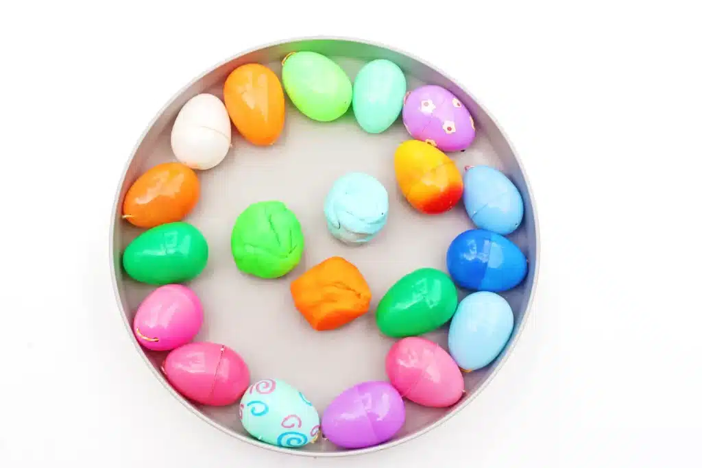 Easter Egg Tower STEM Project - Cultivating Brilliant Minds a tray of colored easter eggs and playdough
