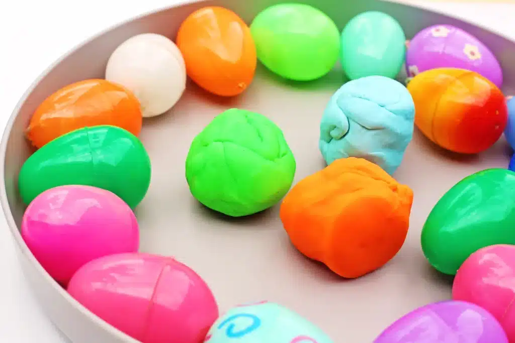 Easter Egg Tower STEM Project - Cultivating Brilliant Minds a tray of colored easter eggs and playdough