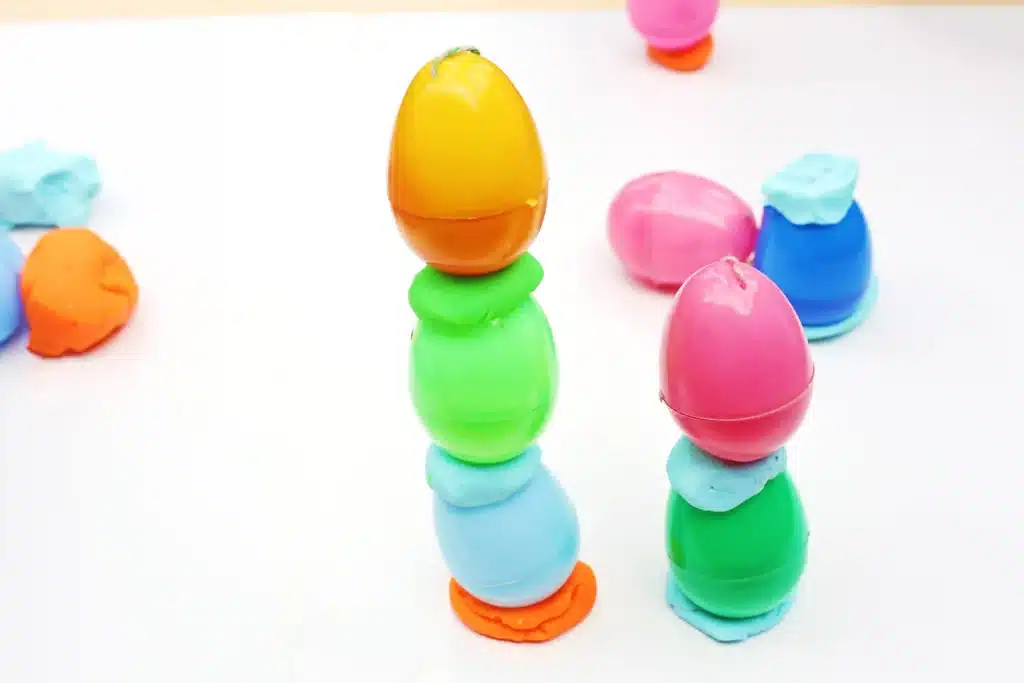 Easter Egg Tower STEM Project - Cultivating Brilliant Minds easter eggs stacked on top of each other with playdough in the middle to hold them up