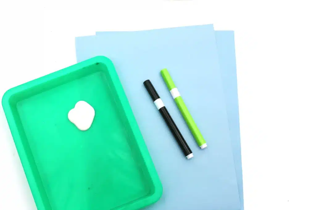 Fingerprint Dandelions - Cultivating Brilliant Minds blue paper, white paint, green and black markers