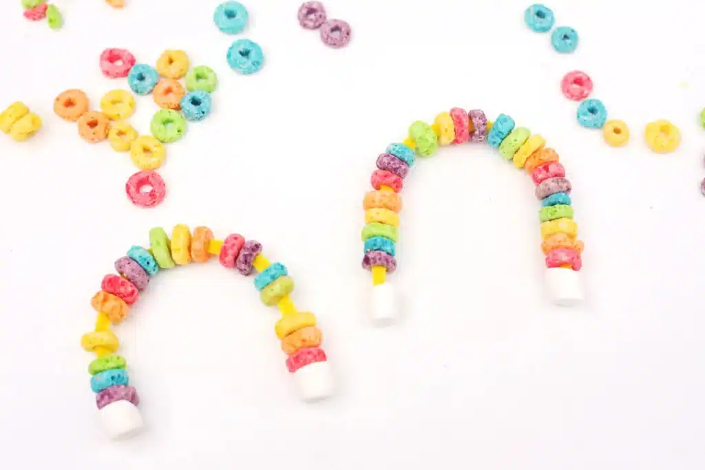 Fruit Loops Rainbow Snack - Cultivating Brilliant Minds a rainbow made out of froot loops and marshmallows on pipe cleaners