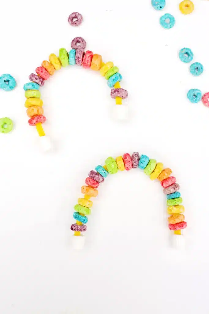 Fruit Loops Rainbow Snack - Cultivating Brilliant Minds a rainbow made out of froot loops and marshmallows on pipe cleaners