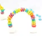 Fruit Loops Rainbow Snack - Cultivating Brilliant Minds a rainbow made out of froot loops and marshmallows on pipe cleaners