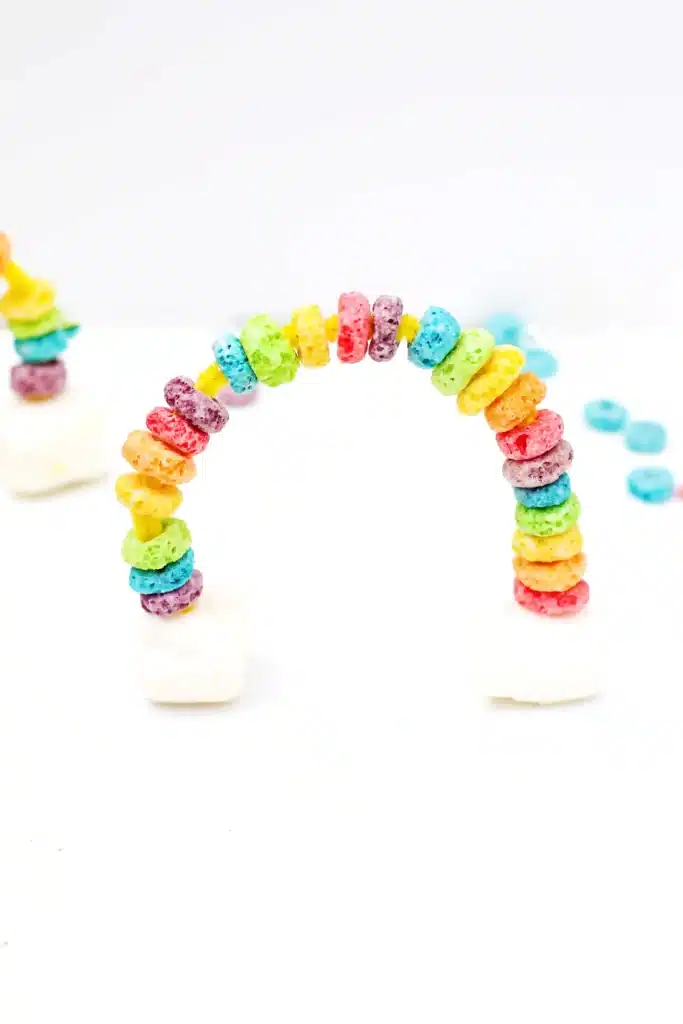 Fruit Loops Rainbow Snack - Cultivating Brilliant Minds a rainbow made out of froot loops and marshmallows on pipe cleaners