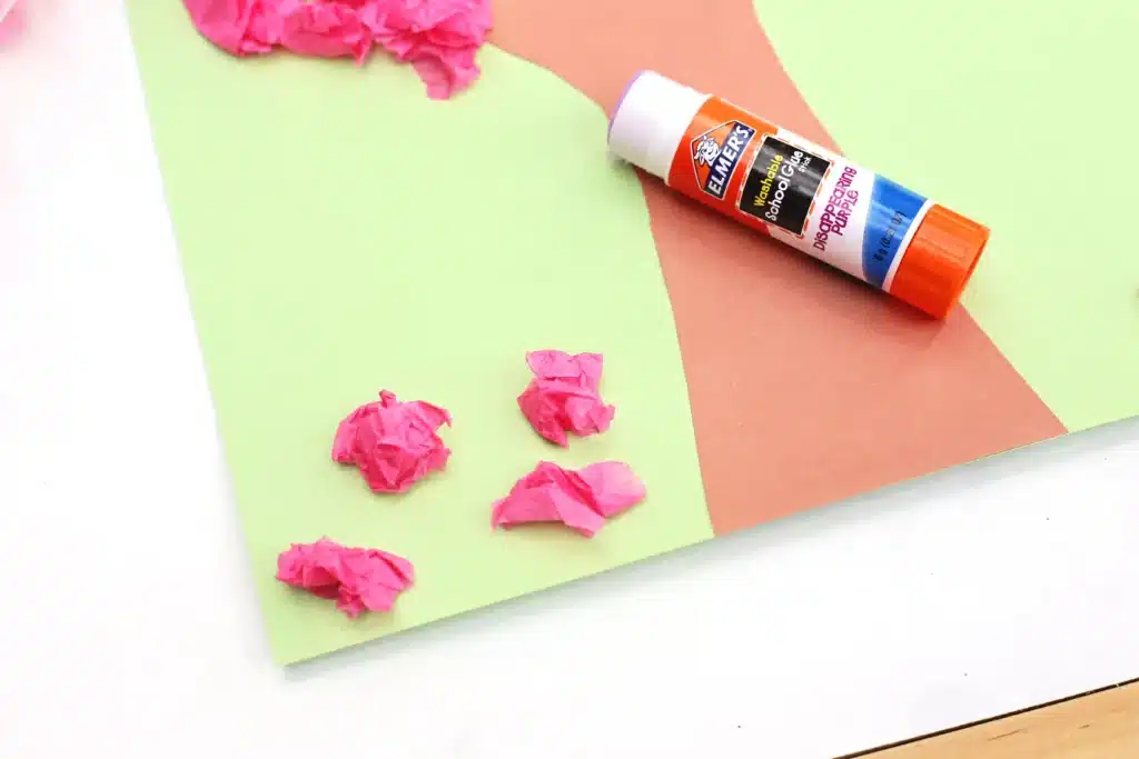 Handprint Cherry Blossom Tree - Cultivating Brilliant Minds crumbled pink tissue paper glued to a handprint trunk