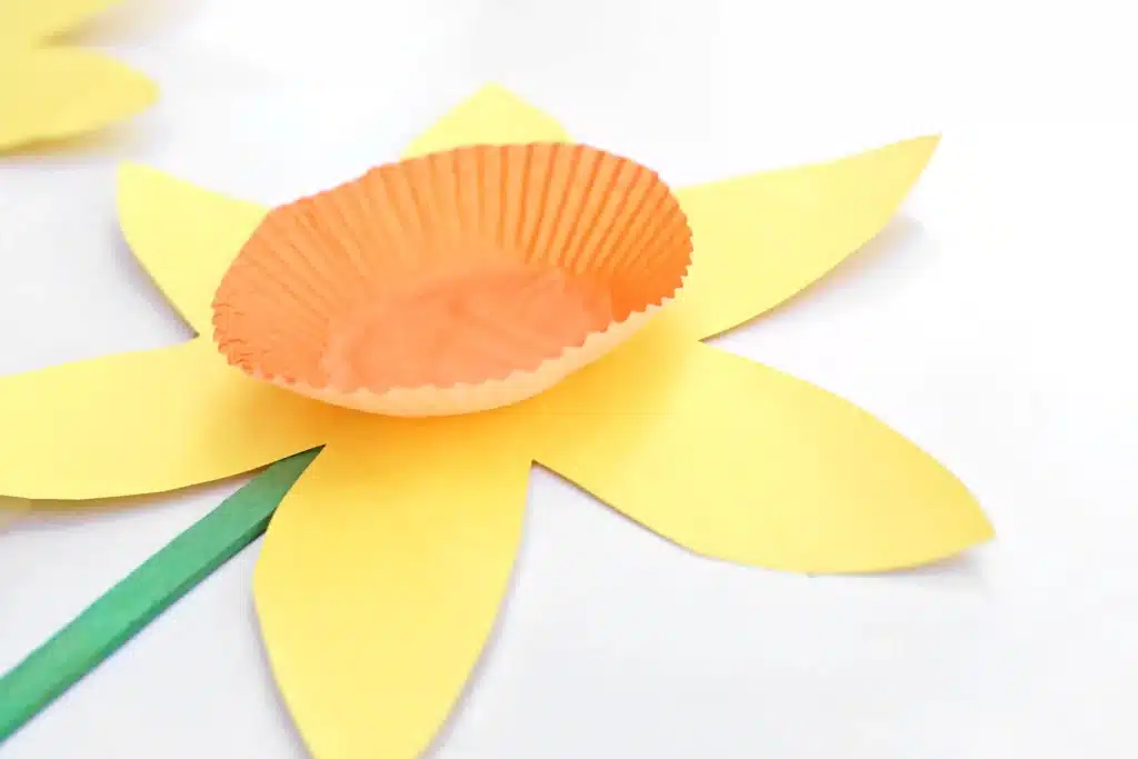 Cupcake Liner Daffodil - Cultivating Brilliant Minds an orange cupcake liner glued to a flower cut out of yellow construction paper