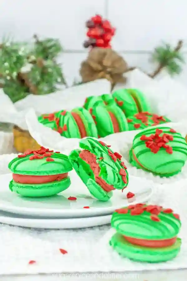 Dr. Seuss Inspired Treats - Cultivating Brilliant Minds green macaroons with red icing in the middle and red sprinkles on top