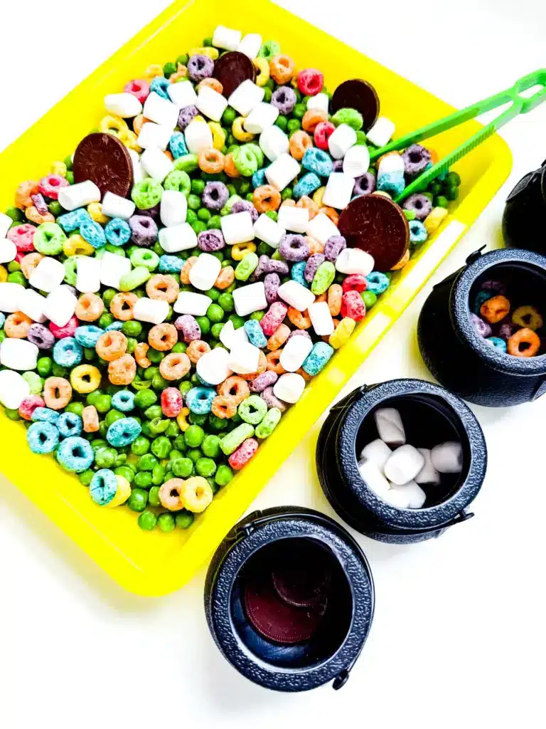 Edible St. Patrick's Day Sensory Bin - Cultivating Brilliant Minds a st. patrick's day sensory bin that has green peas, froot loops, marshmallows, and chocolate coins.