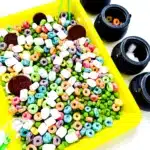 Edible St. Patrick's Day Sensory Bin - Cultivating Brilliant Minds a st. patrick's day sensory bin that has green peas, froot loops, marshmallows, and chocolate coins.