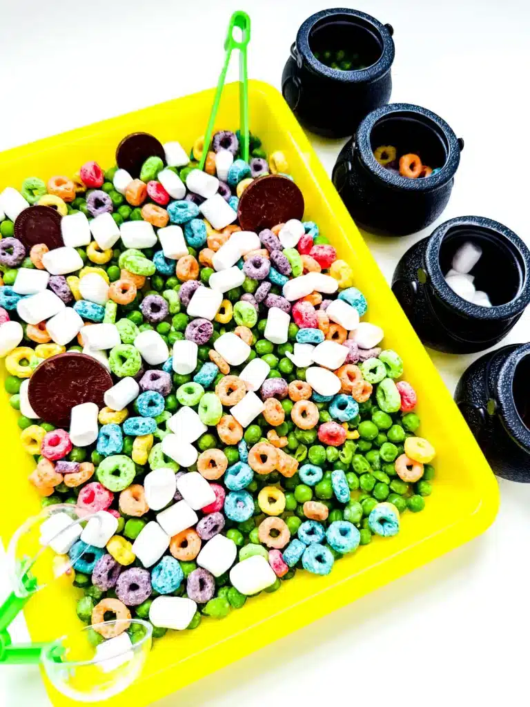 Edible St. Patrick's Day Sensory Bin - Cultivating Brilliant Minds a st. patrick's day sensory bin that has green peas, froot loops, marshmallows, and chocolate coins.