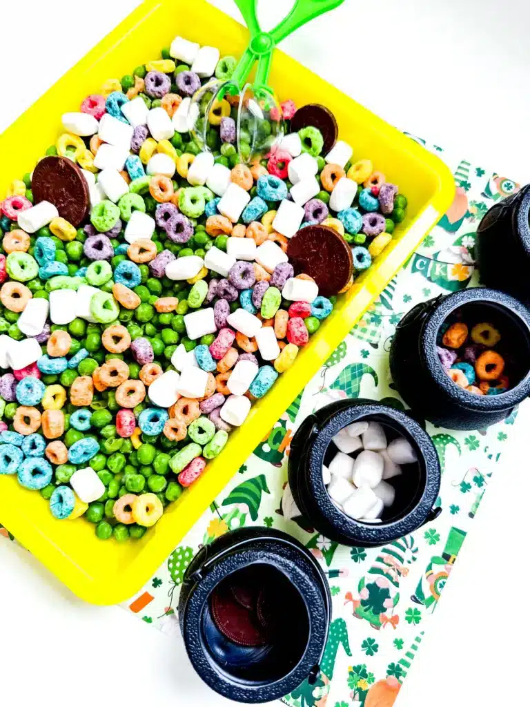 Edible St. Patrick's Day Sensory Bin - Cultivating Brilliant Minds a st. patrick's day sensory bin that has green peas, froot loops, marshmallows, and chocolate coins.