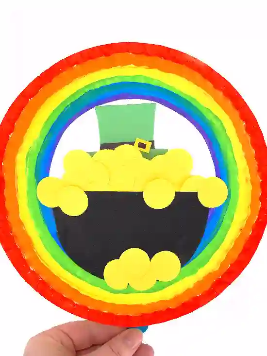 St. Patrick's Day Paper Plate Crafts - Cultivating Brilliant Minds a paper plate painted to look like a rainbow with the pot of gold in the middle.