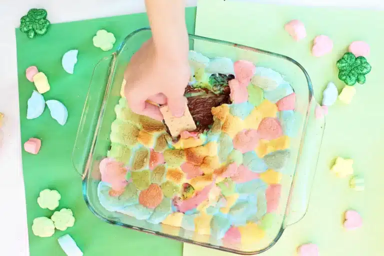 a lucky charms s'mores dip that uses melted chocolate, graham crackers, and lucky charms marshmallows