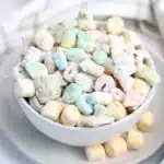 Lucky Charms Puppy Chow for St. Patrick's Day - Cultivating Brilliant Minds st. patrick's day muddie buddies in a white bowl