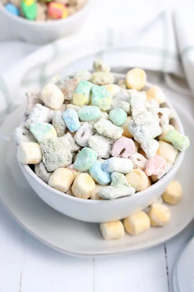 Lucky Charms Puppy Chow for St. Patrick's Day - Cultivating Brilliant Minds st. patrick's day muddie buddies in a white bowl