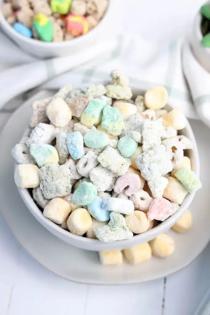 Lucky Charms Puppy Chow for St. Patrick's Day - Cultivating Brilliant Minds lucky charms puppy chow muddie buddies in a white bowl