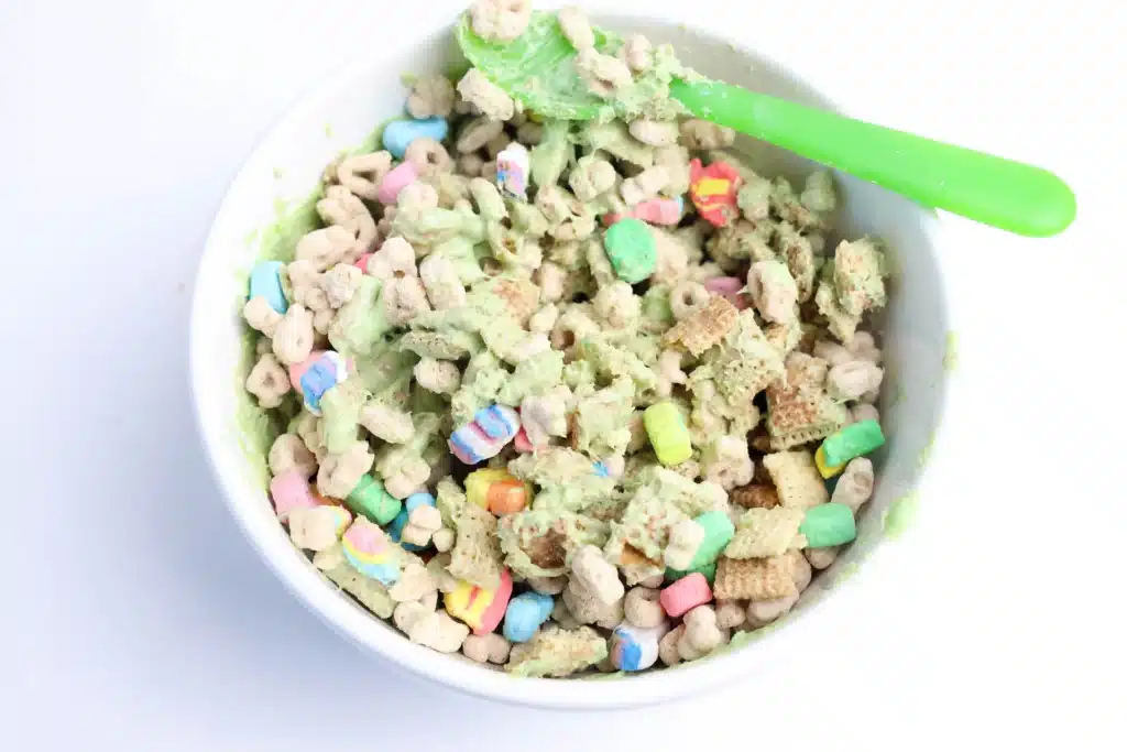 Lucky Charms Puppy Chow for St. Patrick's Day - Cultivating Brilliant Minds chex mmix and lucky charms coated with green melted candy melts