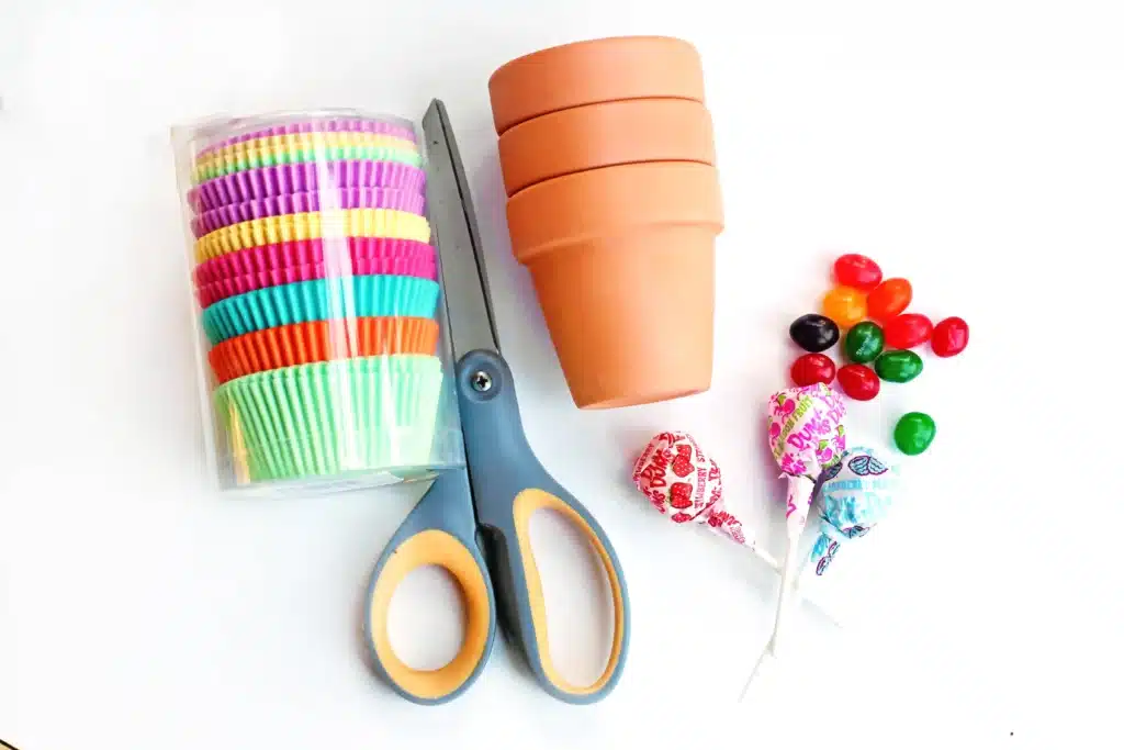 Magic Jelly Bean Easter activity for kids - Cultivating Brilliant Minds cupcake liners, clay pots, lolipops, jelly beans, and scissors are needed for this easter treat idea for kids