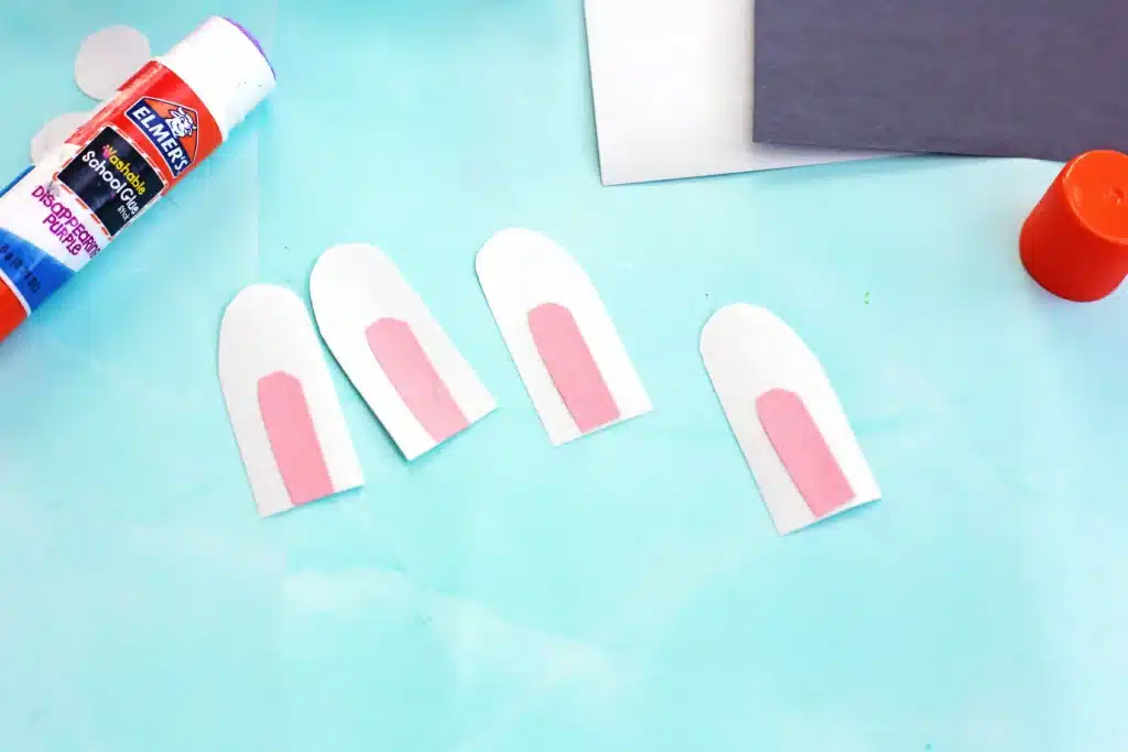 Little Debbie Easter Bunny Cakes - Cultivating Brilliant Minds bunny ears cut out of white and pink construction paper