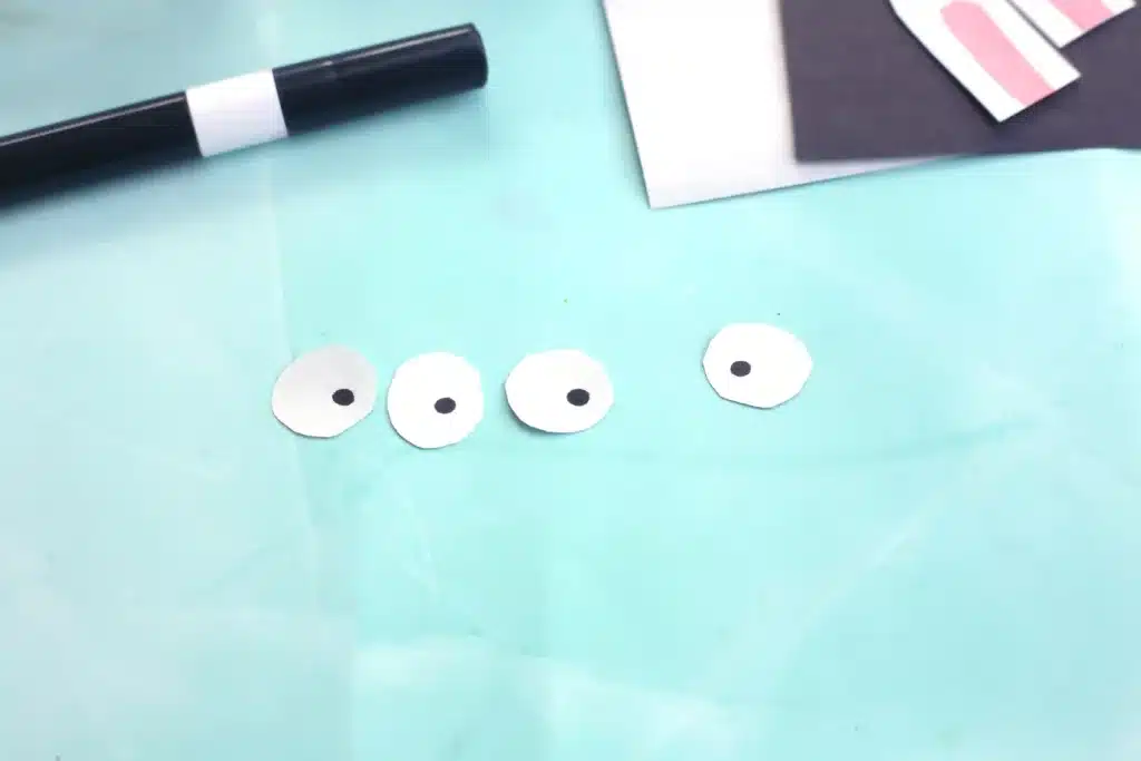 Little Debbie Easter Bunny Cakes - Cultivating Brilliant Minds circles cut out of white construction paper with black dots on them for pupils