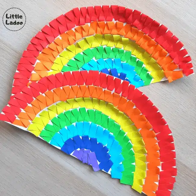 St. Patrick's Day Paper Plate Crafts - Cultivating Brilliant Minds A paper plate cut in half and decorated to look like a rainbow