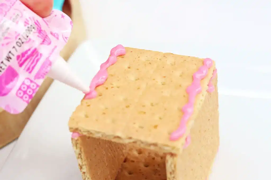 Peeps House STEM Challenge - Cultivating Brilliant Minds icing on the top of a house made out of four graham crackers stuck together with icing