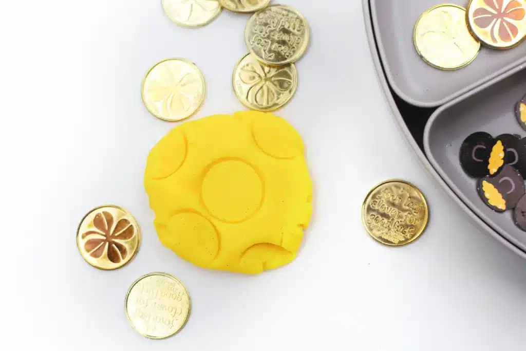 Pot of Gold Playdough Tray - Cultivating Brilliant Minds yellow playdough with gold coins pressed in it