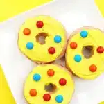 Dr. Seuss Put Me in the Zoo Donuts - Cultivating Brilliant Minds glazed donuts with yellow icing and red and blue m&ms on top
