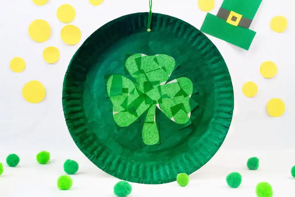 St. Patrick's Day Paper Plate Crafts - Cultivating Brilliant Minds a paper plate suncatcher that has a shamrock in the middle