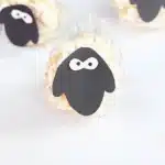 Sheep Popcorn Balls - Cultivating Brilliant Minds a popcorn ball with a construction paper sheep face on it to make a sheep popcorn ball
